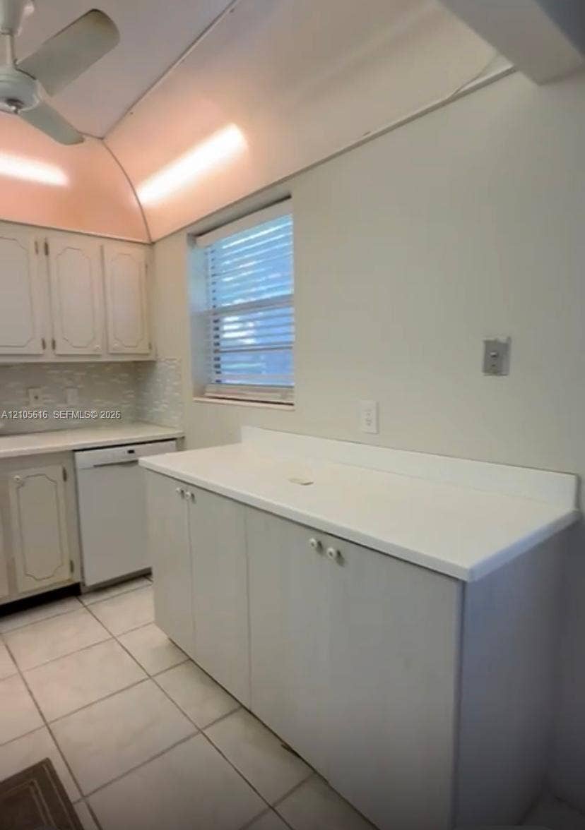 573 Durham U, #573, Deerfield Beach, FL 33442 Light-toned cabinetry, solid-surface countertops, tile flooring, integrated dishwasher, and recessed ceiling lighting