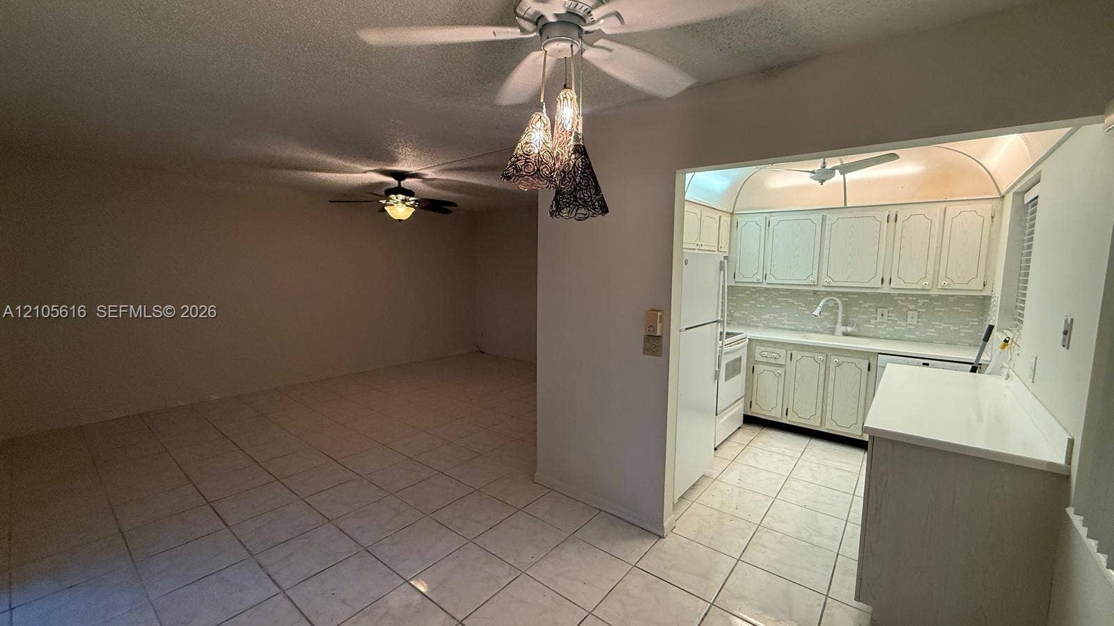 573 Durham U, #573, Deerfield Beach, FL 33442 Interior space featuring tile flooring, ceiling fans with integrated lighting, built-in cabinetry, and white appliance suite