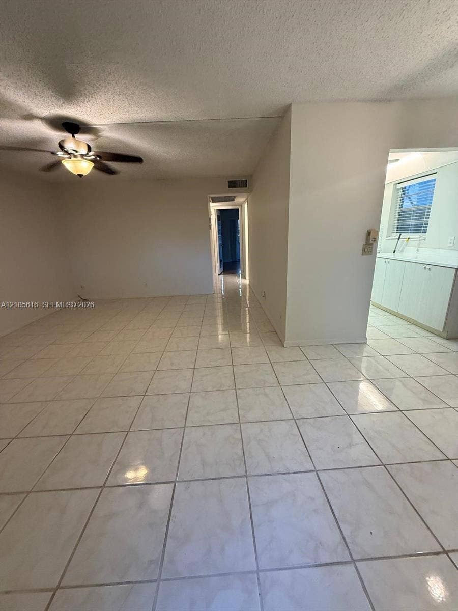 573 Durham U, #573, Deerfield Beach, FL 33442 Glossy tile flooring, neutral wall finishes, and a ceiling fan with integrated lighting