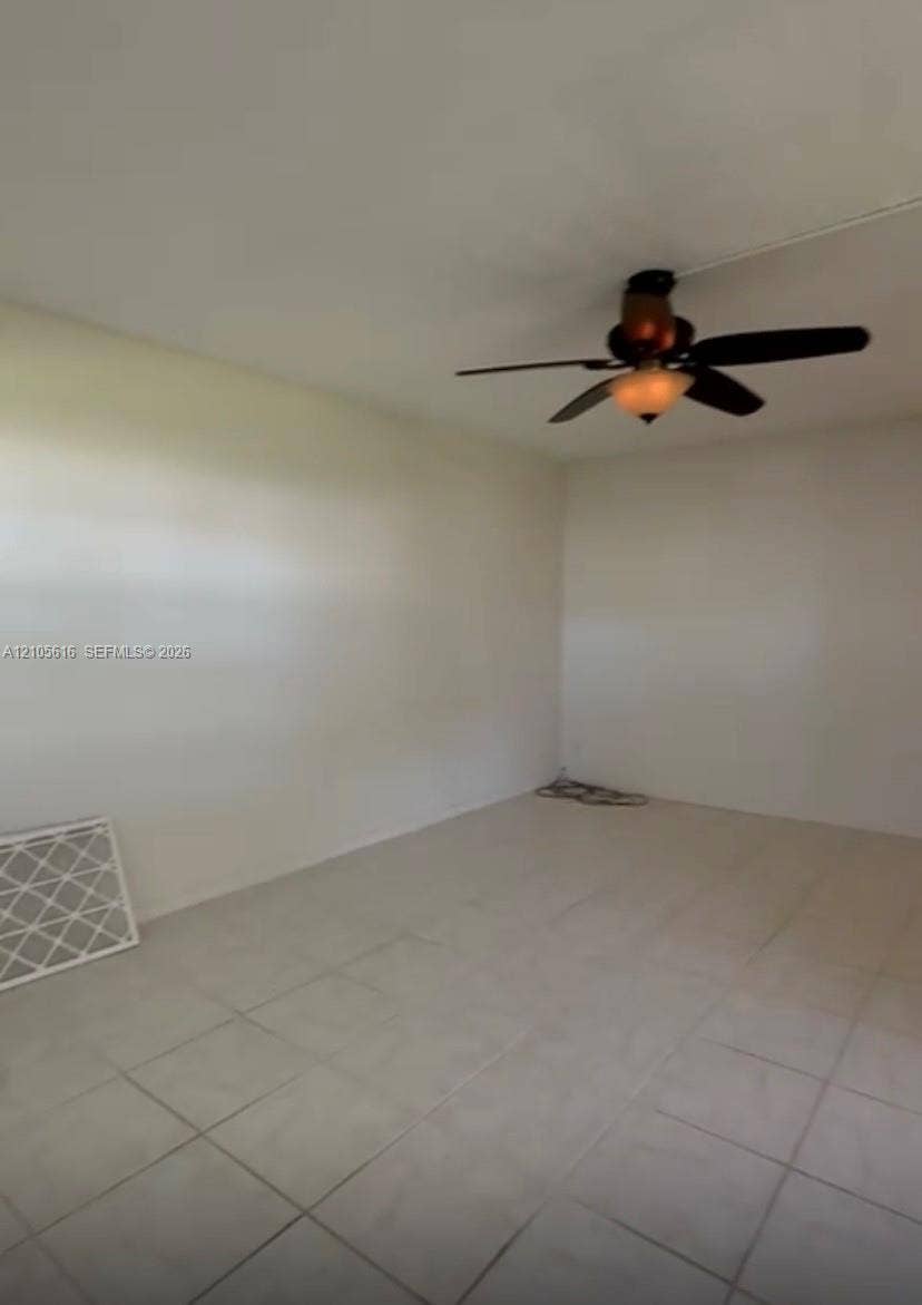 573 Durham U, #573, Deerfield Beach, FL 33442 Neutral interior space featuring light-toned tile flooring and a ceiling-mounted fan with integrated light fixture