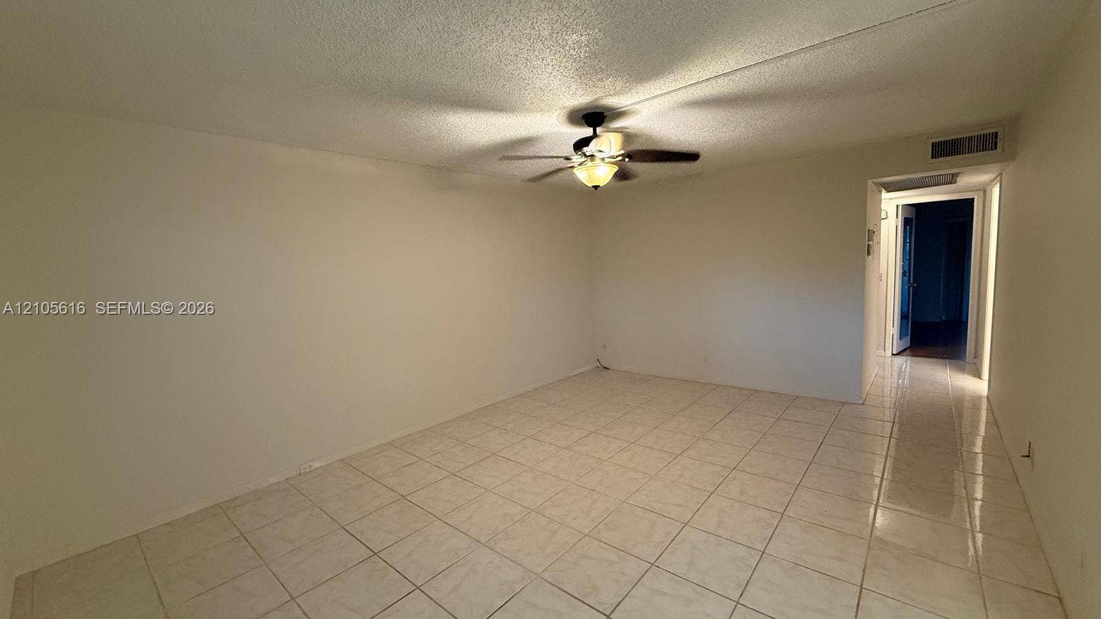 573 Durham U, #573, Deerfield Beach, FL 33442 Spacious room featuring neutral tile flooring, smooth ceilings, and a ceiling-mounted light fixture with a fan
