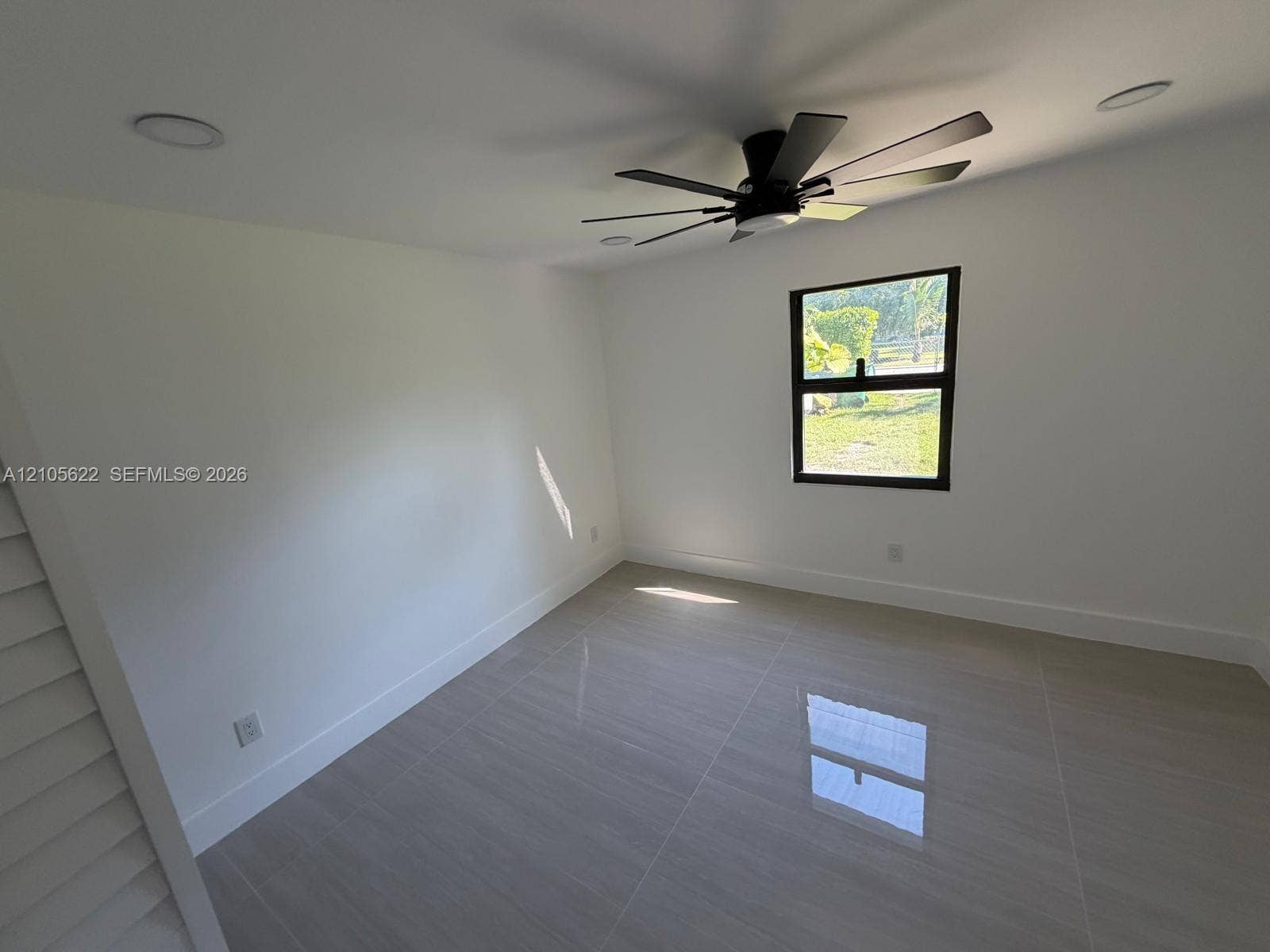 9728 Little River Drive, Miami, FL 33147 Neutral interior featuring large-format ceramic tile flooring, recessed lighting, and a modern multi-blade ceiling fan