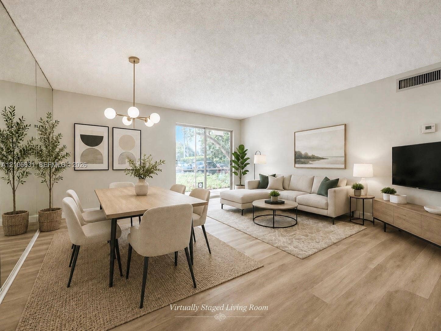 610 NW 13th Street, #0140, Boca Raton, FL 33486 Open-concept living space featuring wood-finish flooring, a wall-to-wall mirrored accent panel, a multi-globe light fixture, and a sliding glass door