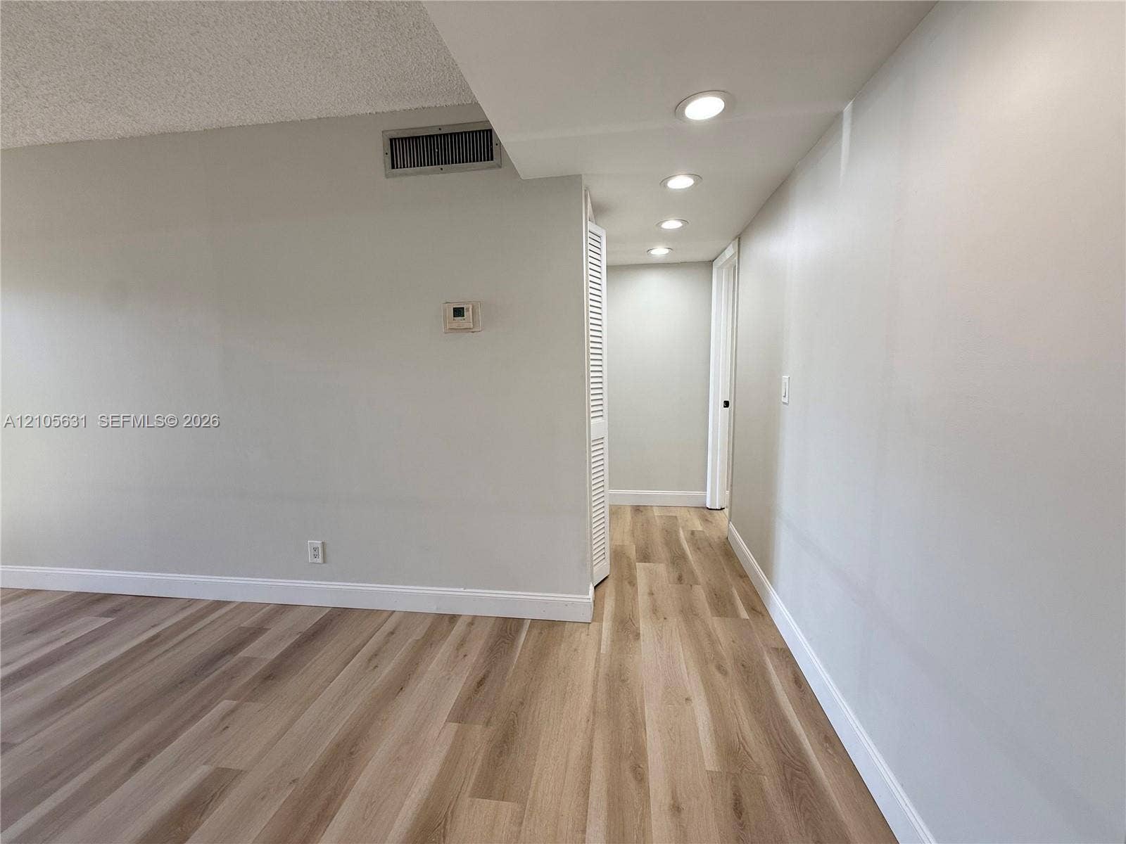 610 NW 13th Street, #0140, Boca Raton, FL 33486 Wood-finish flooring, recessed lighting, and white louvered closet doors