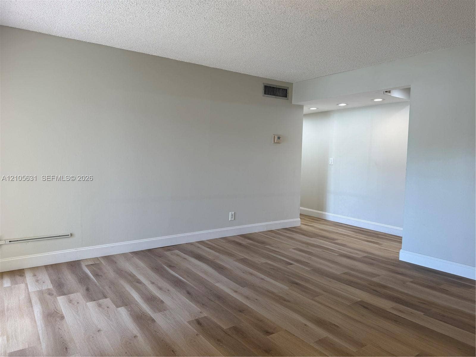 610 NW 13th Street, #0140, Boca Raton, FL 33486 Neutral-toned walls paired with wood-finish flooring and recessed ceiling lighting
