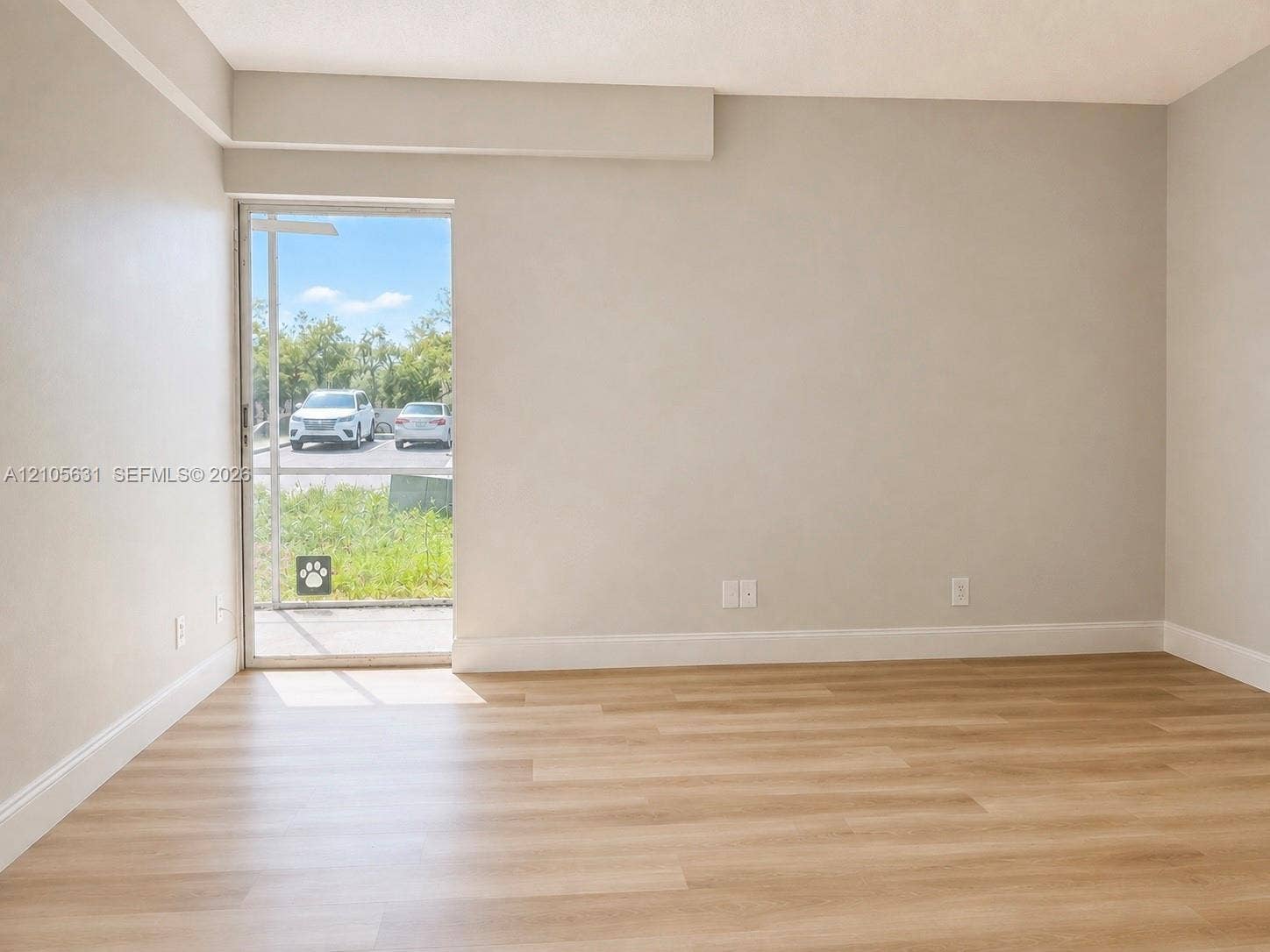 610 NW 13th Street, #0140, Boca Raton, FL 33486 Neutral wall finishes, wood-finish flooring, and sliding glass exterior door