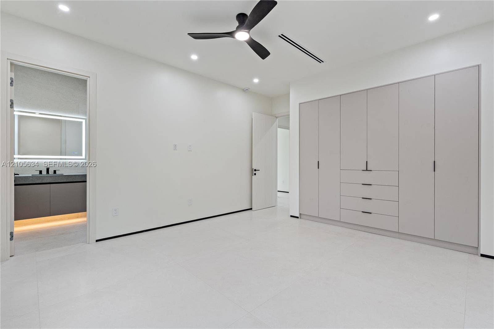 623 NE 16th Terrace, Fort Lauderdale, FL 33304 Built-in floor-to-ceiling cabinetry, recessed lighting, matte black ceiling fan, and large-format tile flooring