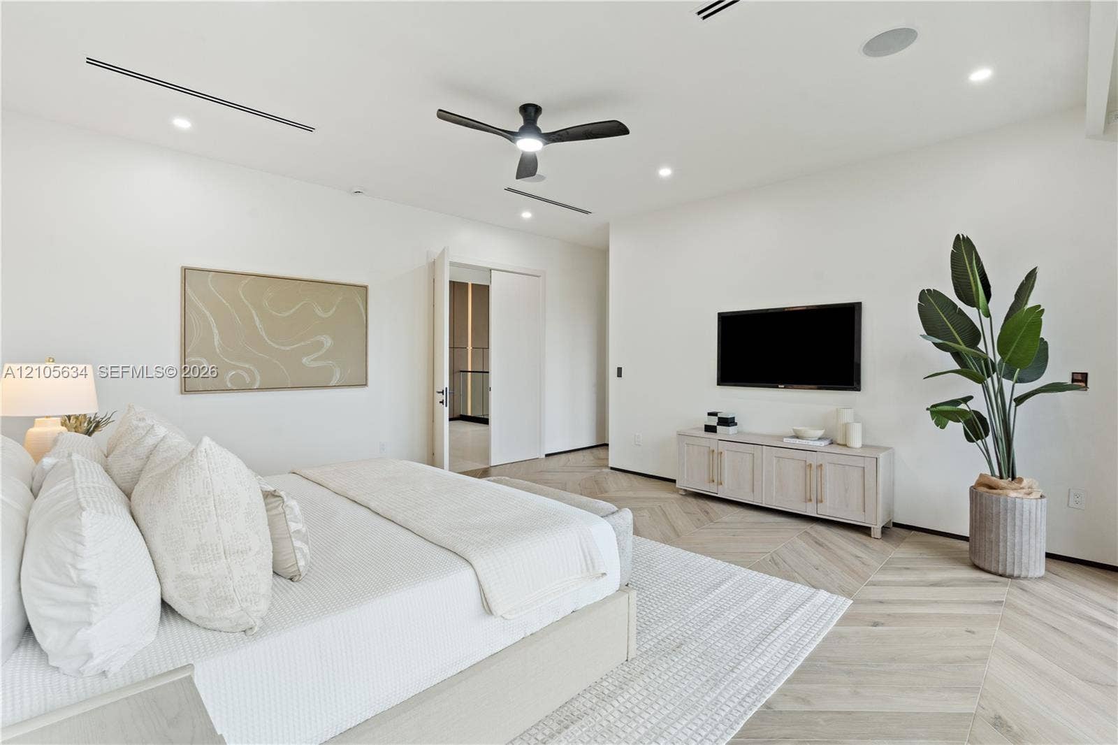 623 NE 16th Terrace, Fort Lauderdale, FL 33304 Herringbone-patterned wood-finish flooring, recessed linear lighting, and integrated ceiling speakers