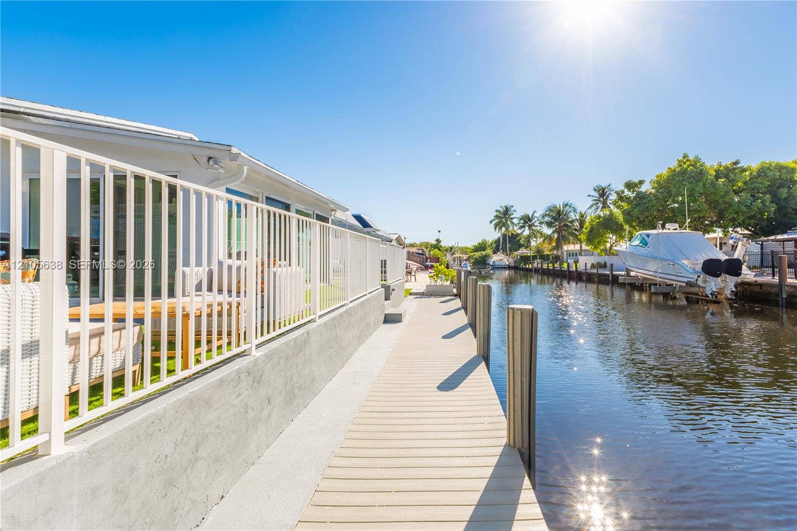 1429 NW 10th Street, #1, Dania, Dania Beach, FL 33004 Waterfront property featuring a private concrete dock, nautical pilings, and a metal perimeter railing