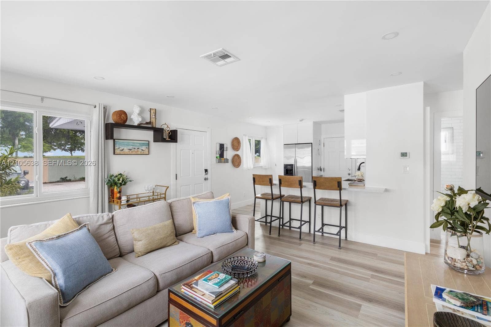 1429 NW 10th Street, #1, Dania, Dania Beach, FL 33004 Open-concept living space featuring wood-finish flooring, recessed lighting, and a kitchen peninsula with breakfast bar seating