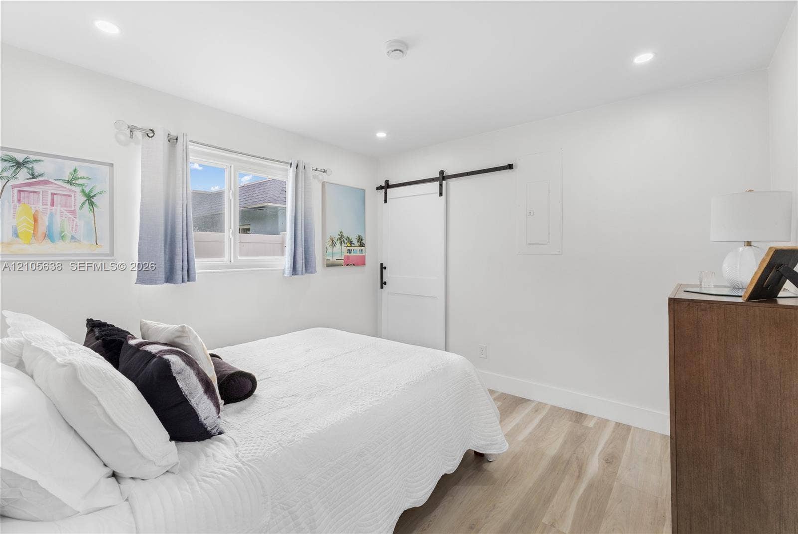 1429 NW 10th Street, #1, Dania, Dania Beach, FL 33004 Wood-finish flooring, recessed lighting, and a white sliding barn door with matte black hardware