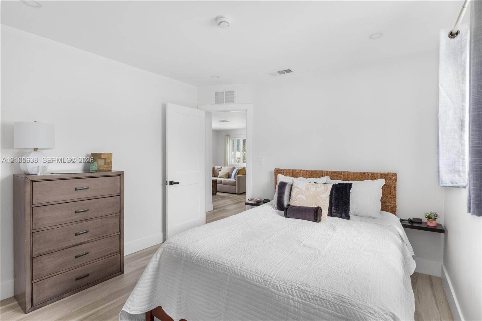 1429 NW 10th Street, #1, Dania, Dania Beach, FL 33004 Neutral interior space featuring wood-finish flooring, recessed lighting, and a solid-core interior door with matte black hardware