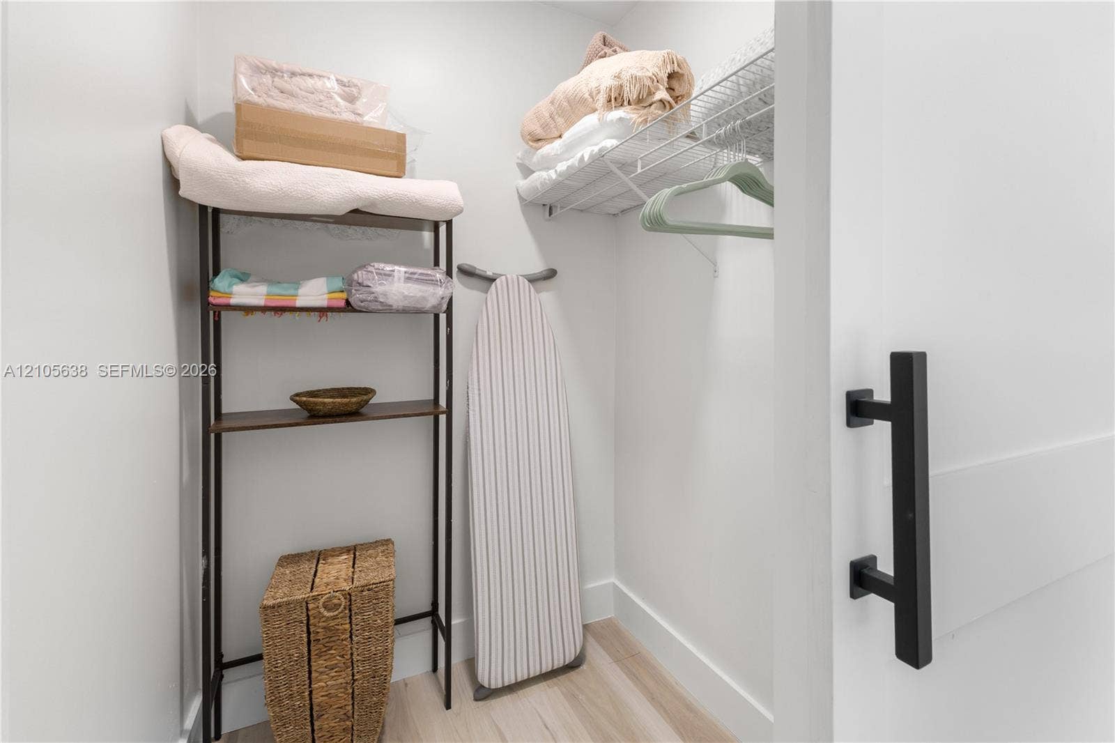1429 NW 10th Street, #1, Dania, Dania Beach, FL 33004 Storage closet featuring a white sliding door with matte black handle hardware and wire shelving