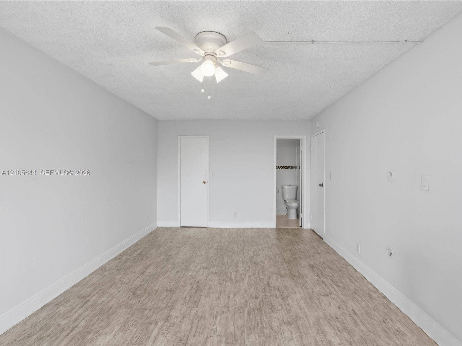 2101 Atlantic Shores Boulevard, #502, Hallandale Beach, Hallandale Beach, FL 33009 Neutral wall tones paired with wood-finish flooring and a multi-blade ceiling fan featuring integrated lighting