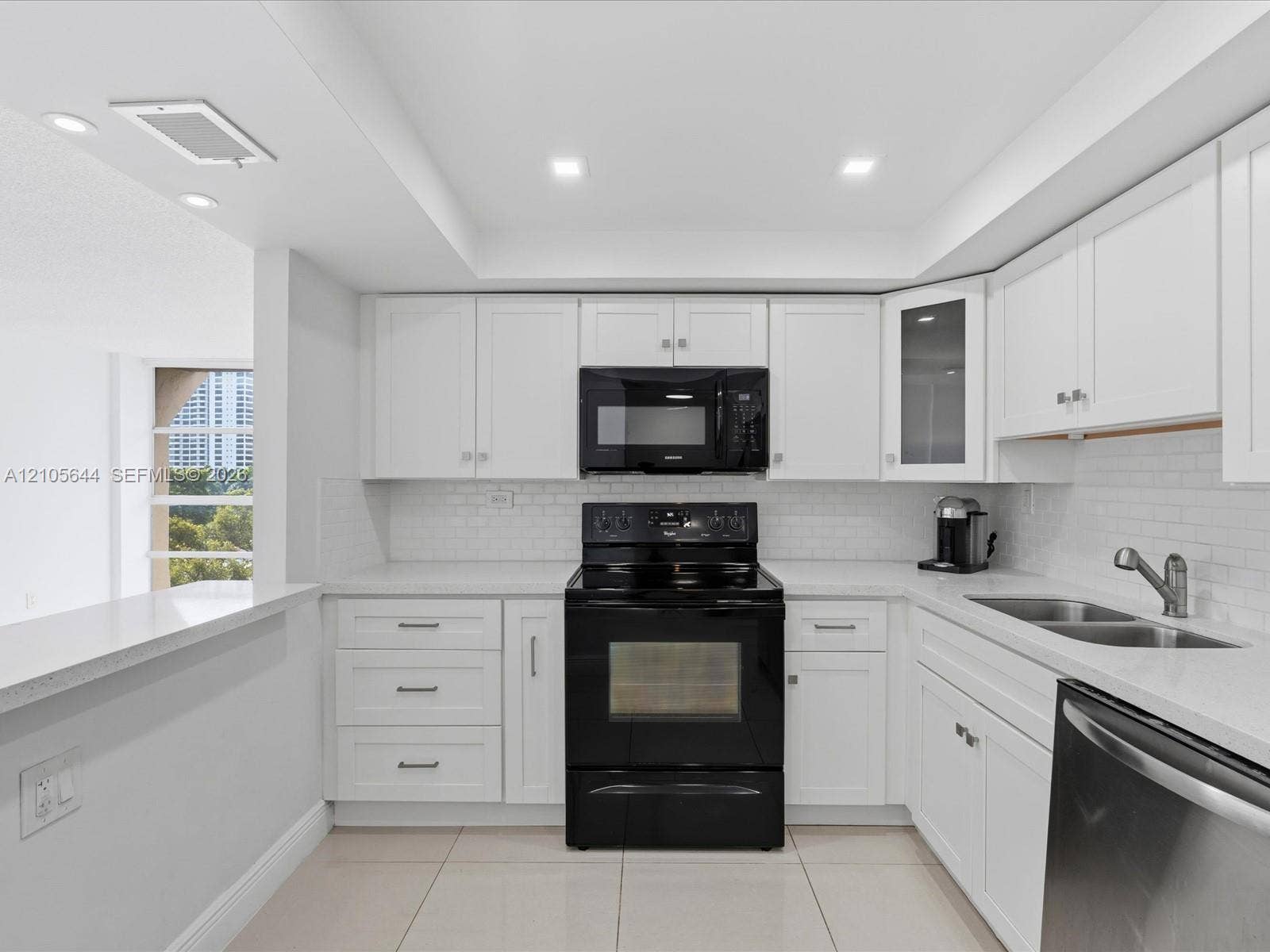 2101 Atlantic Shores Boulevard, #502, Hallandale Beach, Hallandale Beach, FL 33009 Kitchen featuring white shaker cabinetry, quartz countertops, subway tile backsplash, recessed ceiling lighting, and black appliances