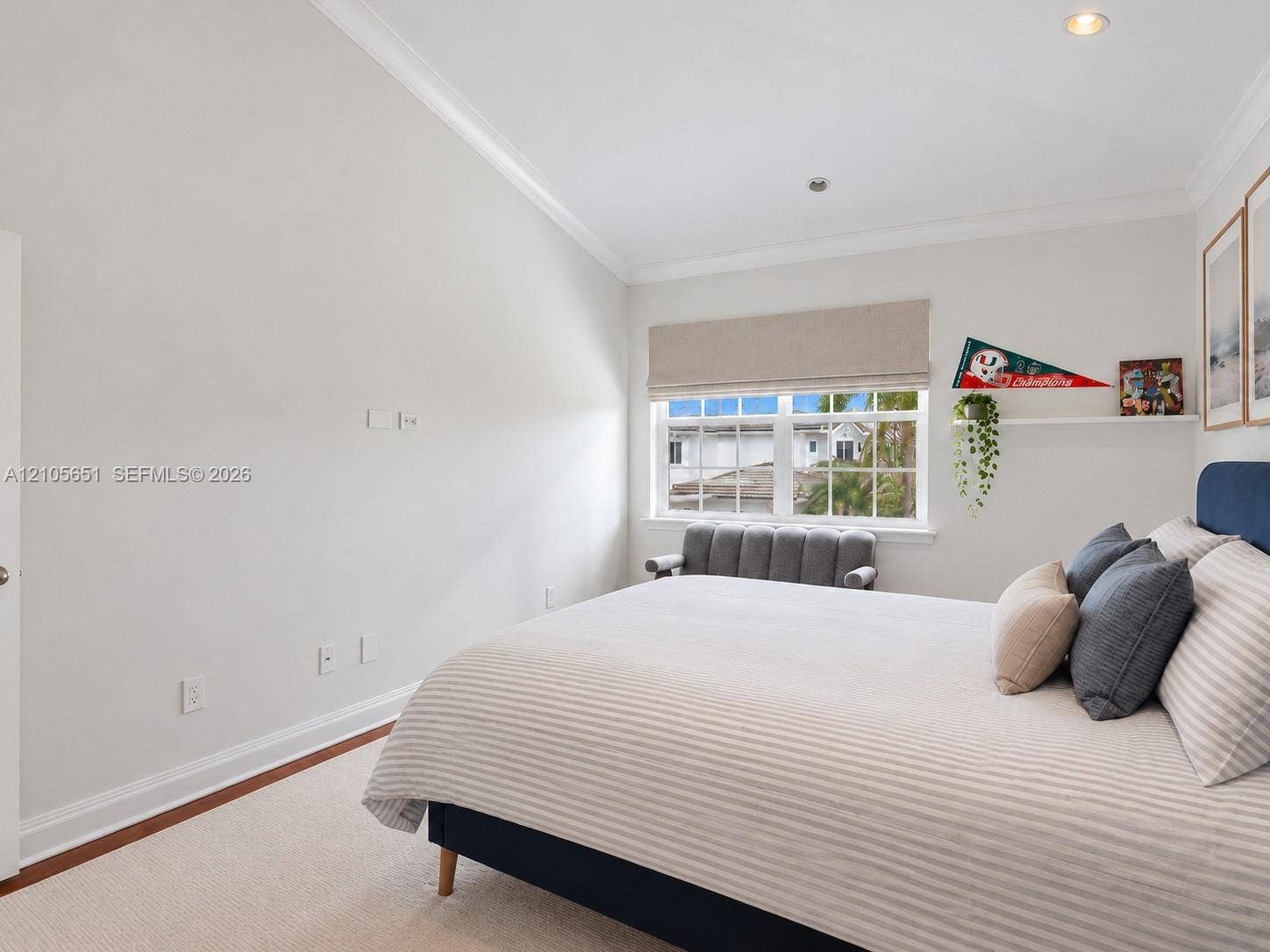 Vaulted ceilings featuring recessed lighting, crown molding, neutral carpeting, and a double-hung window with an integrated blind