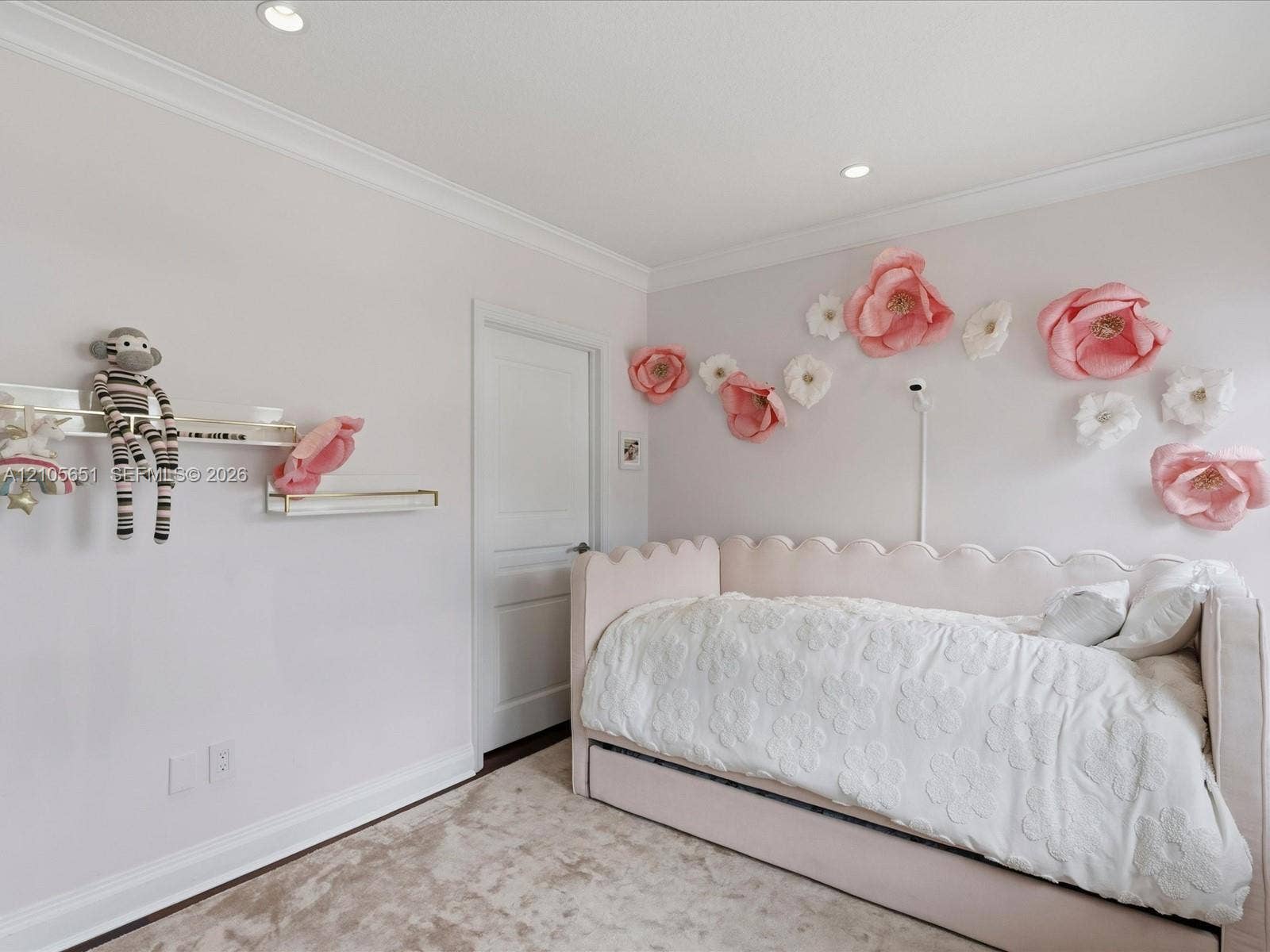 Room featuring crown molding, recessed lighting, and two wall-mounted floating shelves