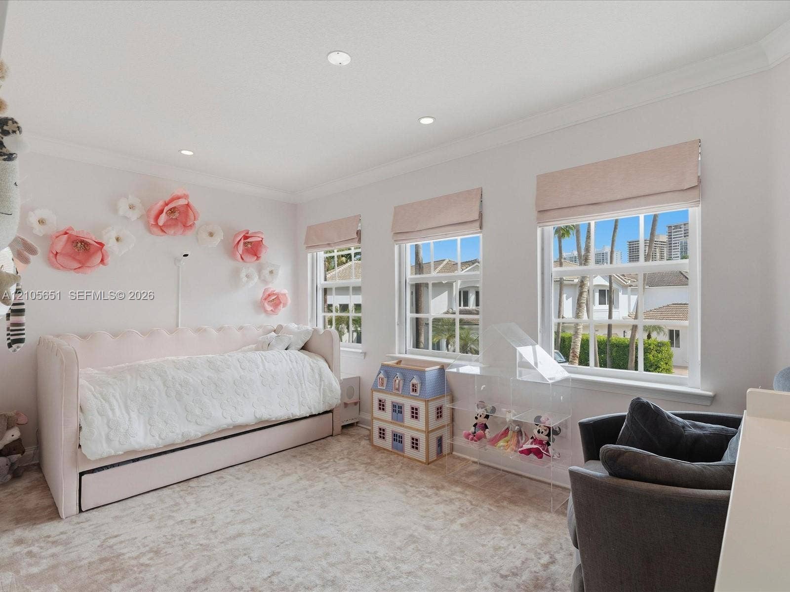 Bright room featuring recessed lighting, crown molding, multi-pane windows, and neutral carpeting