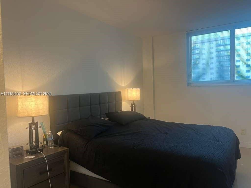 19380 Collins Avenue, #808, Sunny Isles Beach, FL 33160 Large window with neutral-toned horizontal blinds and expansive wall space