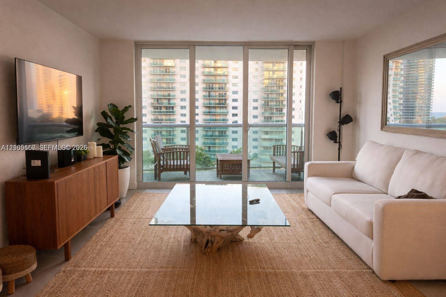 19380 Collins Avenue, #808, Sunny Isles Beach, FL 33160 Floor-to-ceiling sliding glass doors, private balcony, and light-toned interior walls