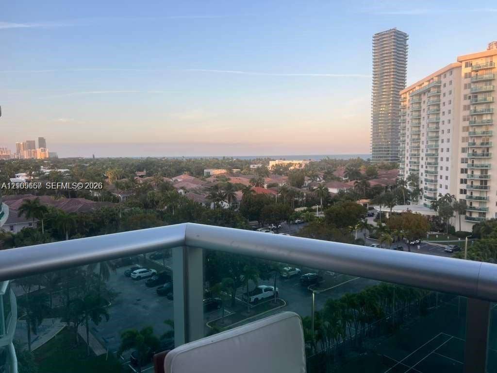 19380 Collins Avenue, #808, Sunny Isles Beach, FL 33160 Balcony featuring a metal railing with glass panels and an expansive skyline and coastal horizon