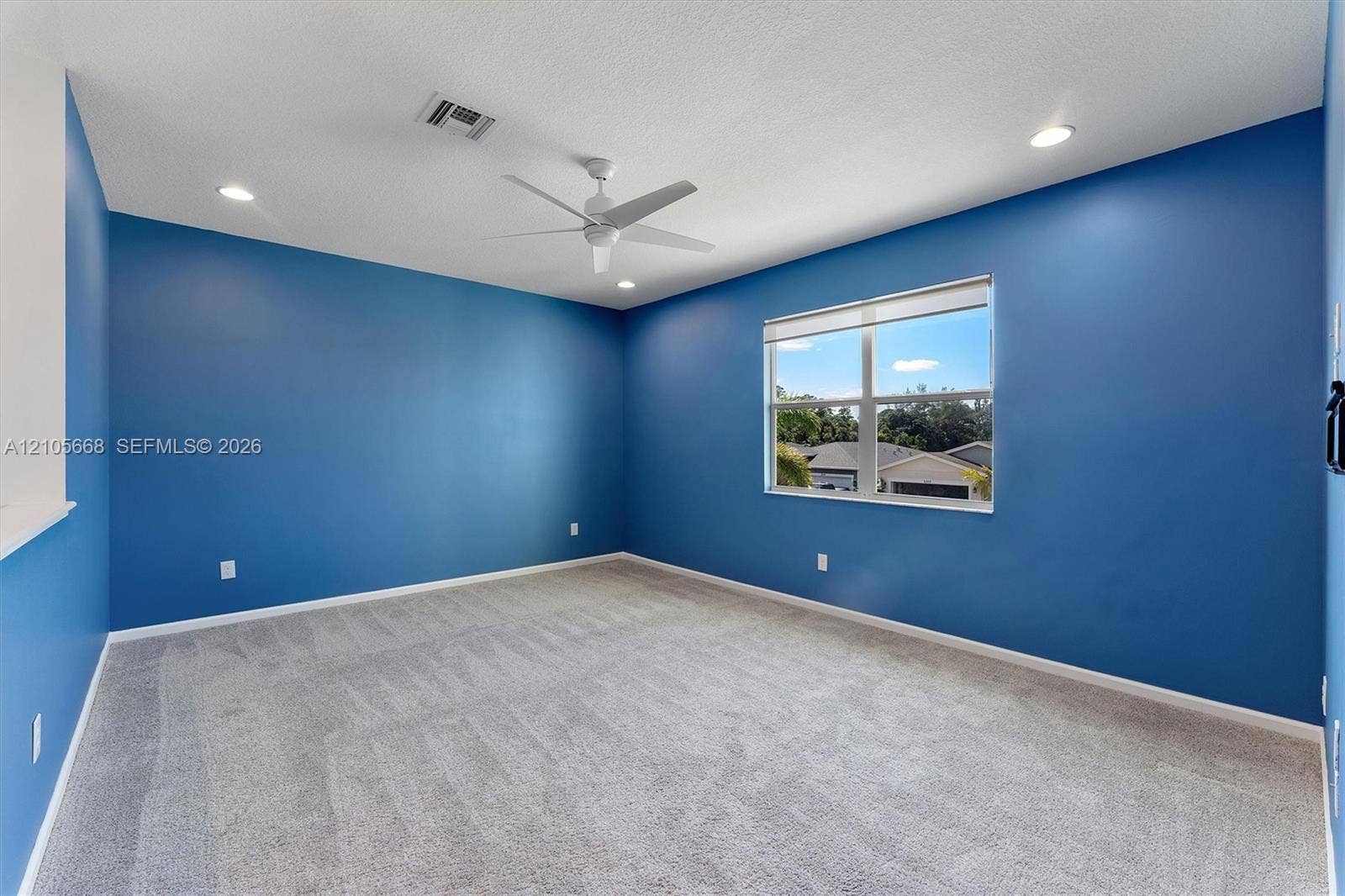 6307 Trails Of Foxford Court, West Palm Beach, FL 33415 Neutral-toned carpeting, recessed lighting, ceiling fan, and large window with blinds