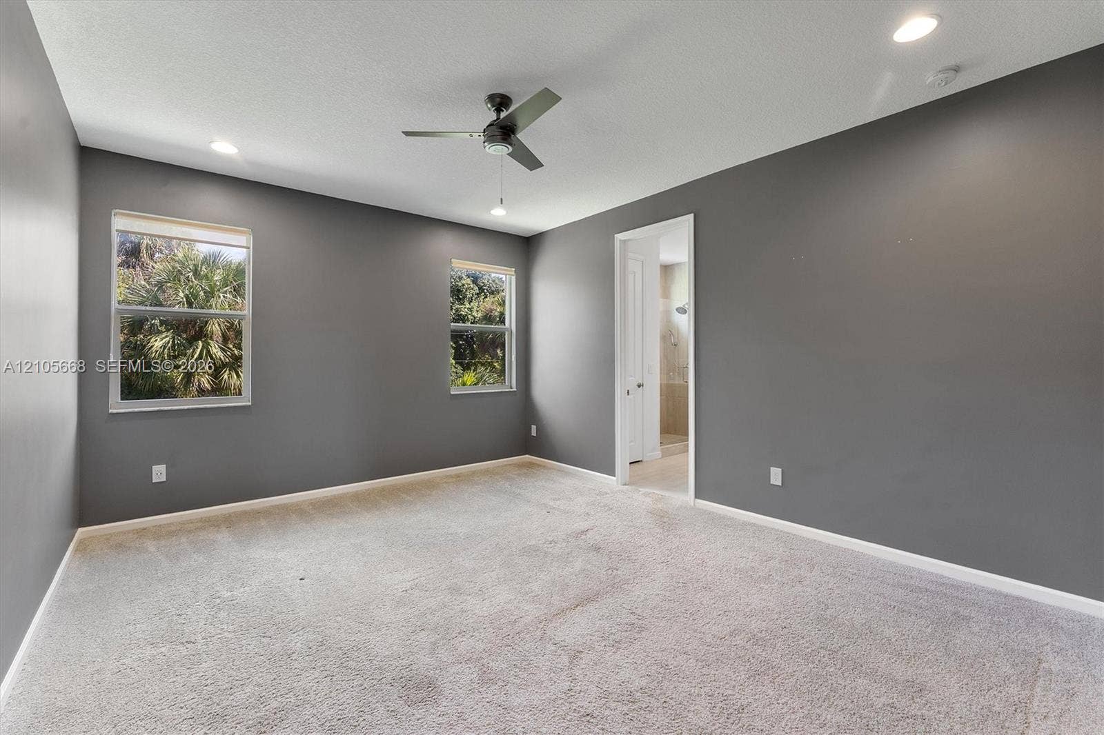 6307 Trails Of Foxford Court, West Palm Beach, FL 33415 Neutral-toned interior featuring wall-to-wall carpeting, recessed lighting, a modern ceiling fan, and dual windows