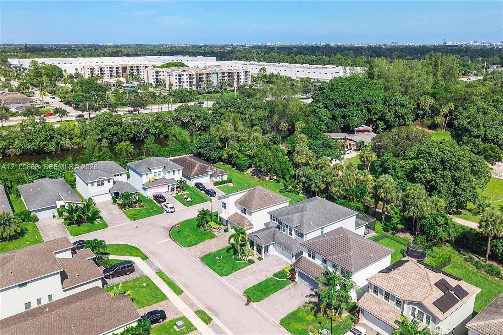 6307 Trails Of Foxford Court, West Palm Beach, FL 33415 Aerial perspective of a suburban neighborhood featuring multi-story dwellings, tile roofing, paved streets, manicured lawns, and mature tree canopy