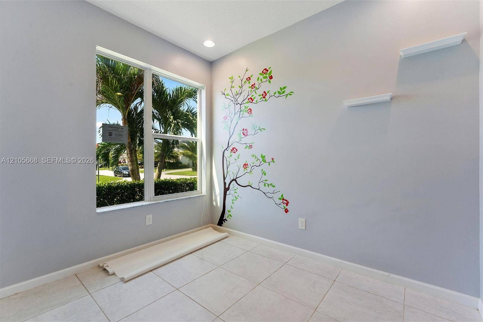 6307 Trails Of Foxford Court, West Palm Beach, FL 33415 Neutral wall palette featuring a single-pane window, tile flooring, recessed ceiling lighting, and two mounted floating shelves