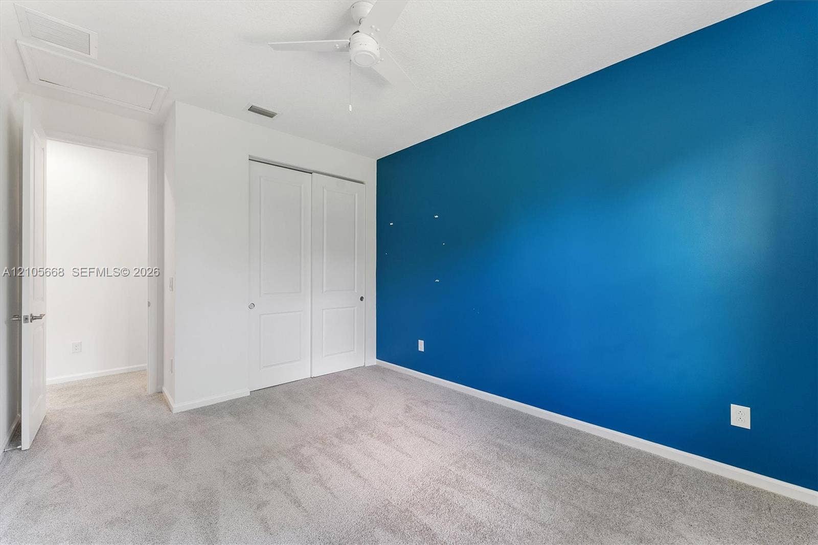 6307 Trails Of Foxford Court, West Palm Beach, FL 33415 Room featuring neutral wall-to-wall carpeting, a dual-panel closet, and a ceiling fan