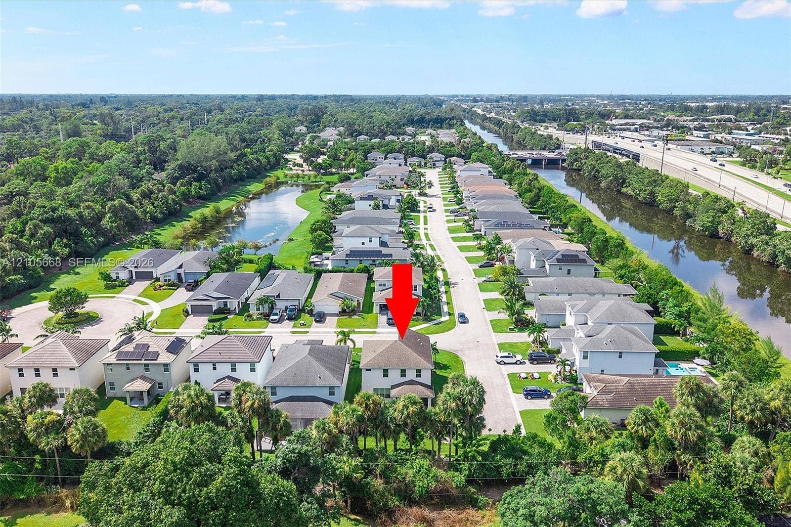 6307 Trails Of Foxford Court, West Palm Beach, FL 33415 Two-story residence featuring a hipped roof, light-toned exterior finish, and a concrete driveway