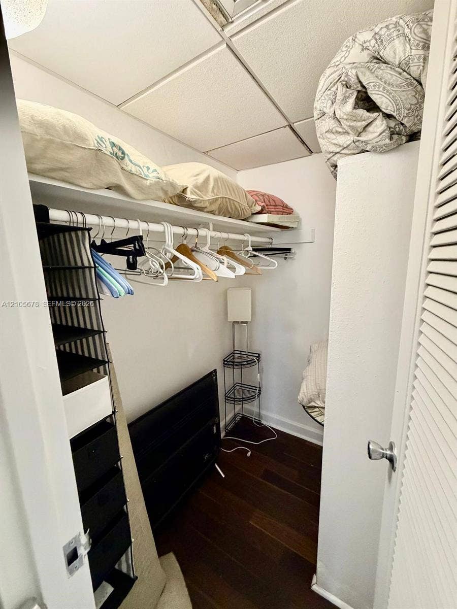 4001 S Ocean Drive, #14F, Hollywood, FL 33019 Storage closet featuring wood-finish flooring, a full-length overhead shelf, and a mounted metal garment rod