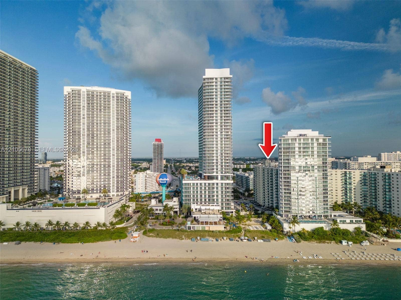 4001 S Ocean Drive, #14F, Hollywood, FL 33019 Aerial perspective of a high-rise residential building situated along a coastal shoreline, featuring direct beach access and proximity to regional urban centers