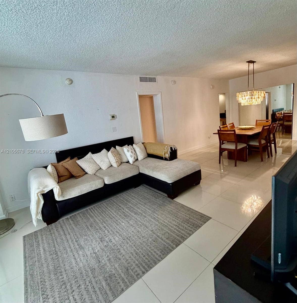 4001 S Ocean Drive, #14F, Hollywood, FL 33019 Large format white tile flooring and decorative multi-tiered crystal chandelier