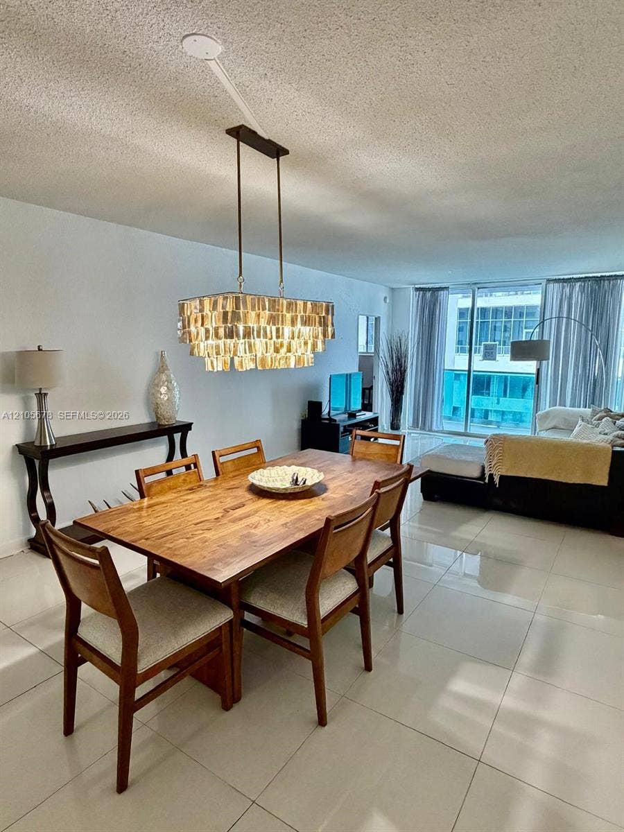 4001 S Ocean Drive, #14F, Hollywood, FL 33019 Large-format tile flooring, multi-tiered rectangular pendant lighting, and floor-to-ceiling sliding glass doors