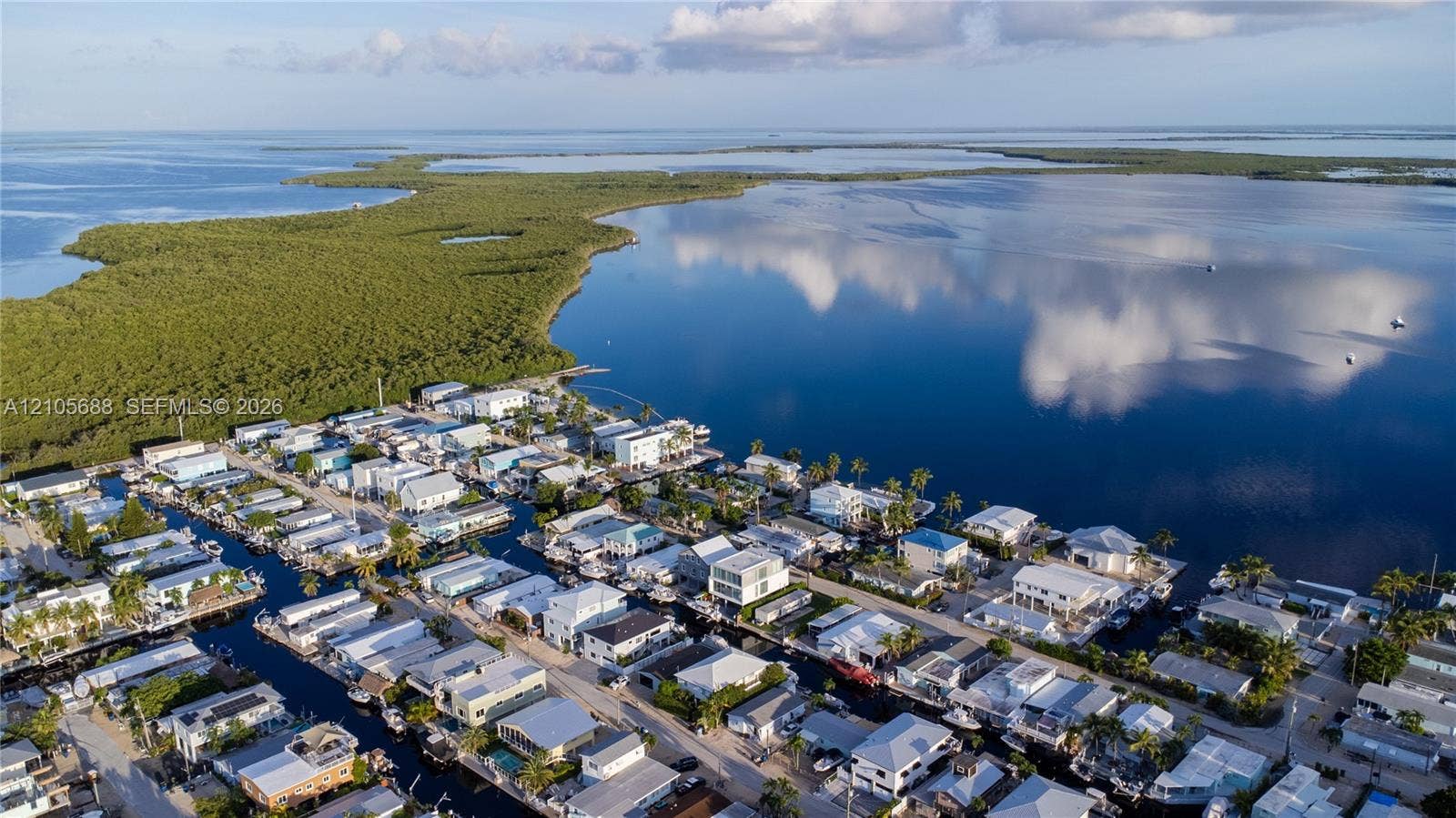 164 W Avenue C, Key Largo, FL 33037 Aerial perspective of waterfront properties featuring deep-water canal access and proximity to open water
