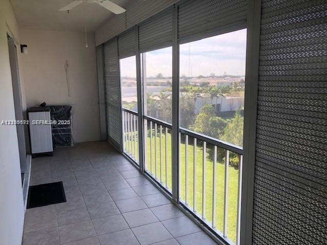 950 Hillcrest Drive, #506, Hollywood, Hollywood, FL 33021 Enclosed balcony featuring tile flooring, ceiling fan, and metal storm shutters