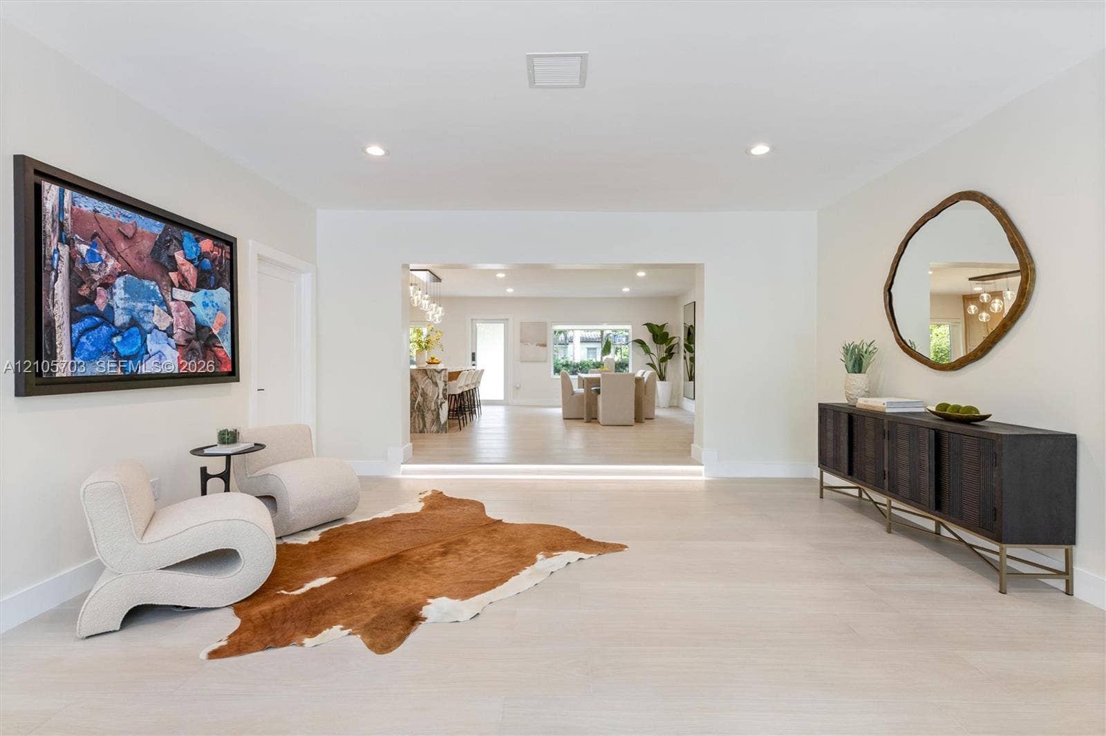 190 NW 102nd Street, Miami Shores, FL 33150 Neutral-toned interior featuring recessed lighting, light-toned wood-finish flooring, and a step-down entryway with integrated riser lighting