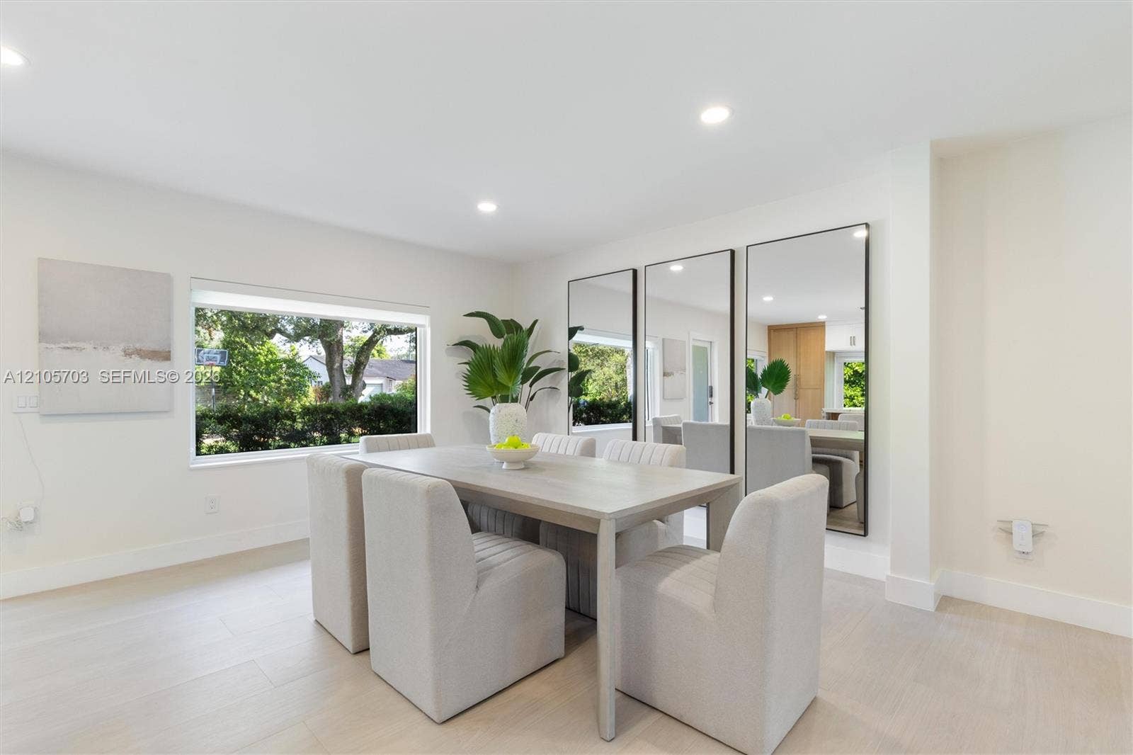 190 NW 102nd Street, Miami Shores, FL 33150 Neutral color palette featuring wood-finish flooring, recessed lighting, and large windows