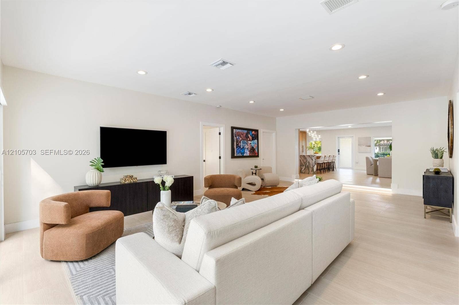 190 NW 102nd Street, Miami Shores, FL 33150 Open-concept interior featuring light wood-finish flooring, neutral wall tones, and recessed lighting