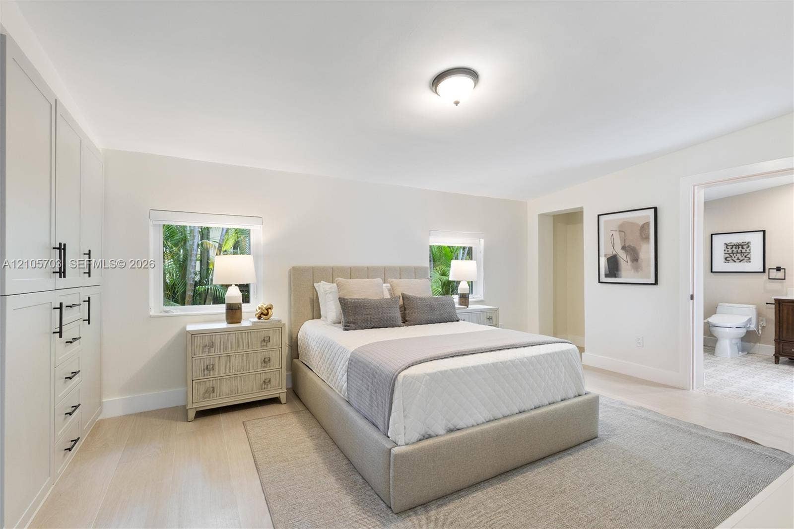 190 NW 102nd Street, Miami Shores, FL 33150 Built-in shaker-style cabinetry with matte black hardware, light wood-finish flooring, and recessed ceiling lighting