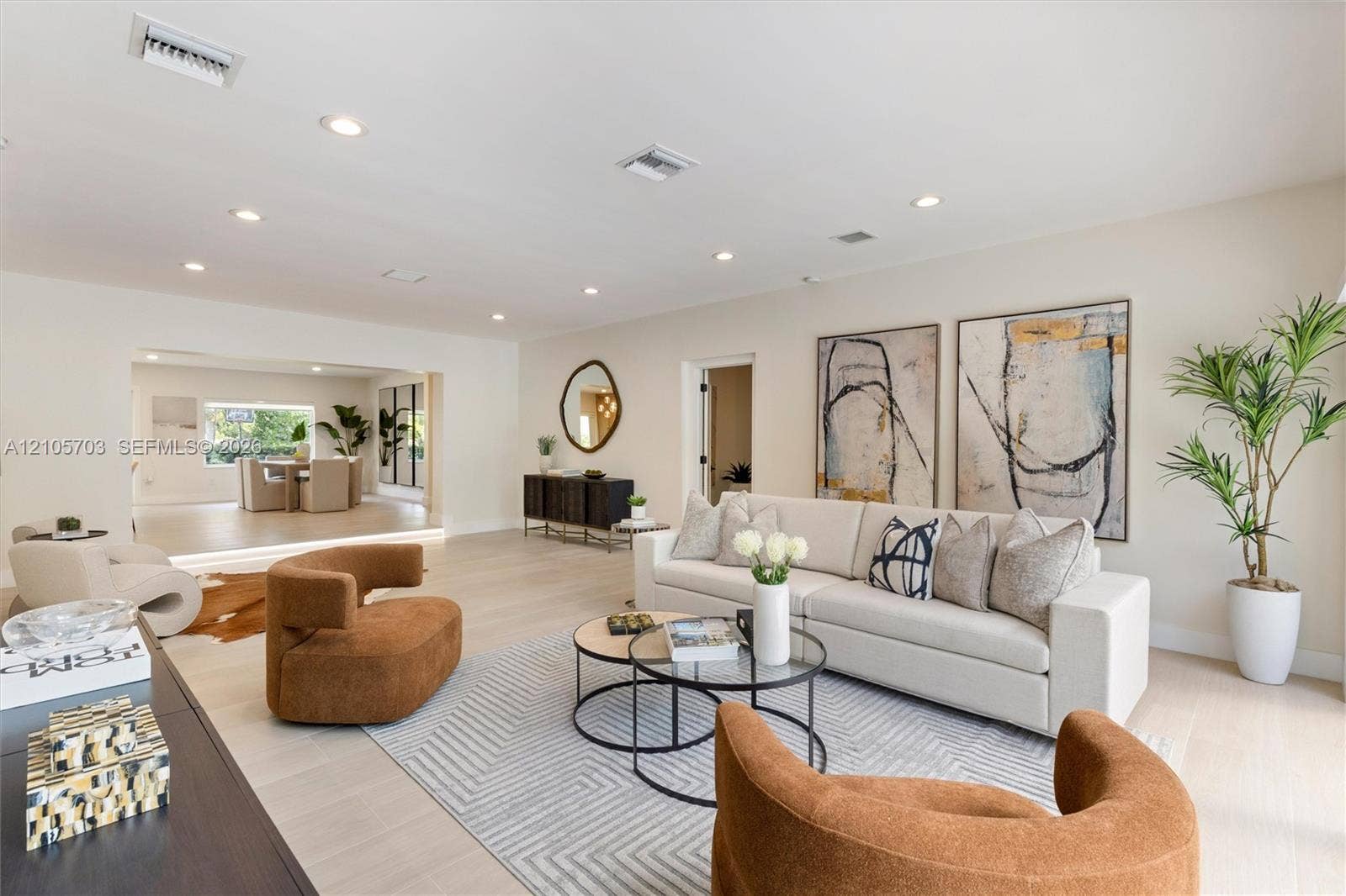 190 NW 102nd Street, Miami Shores, FL 33150 Open-concept room featuring light-toned wood-finish flooring and recessed lighting