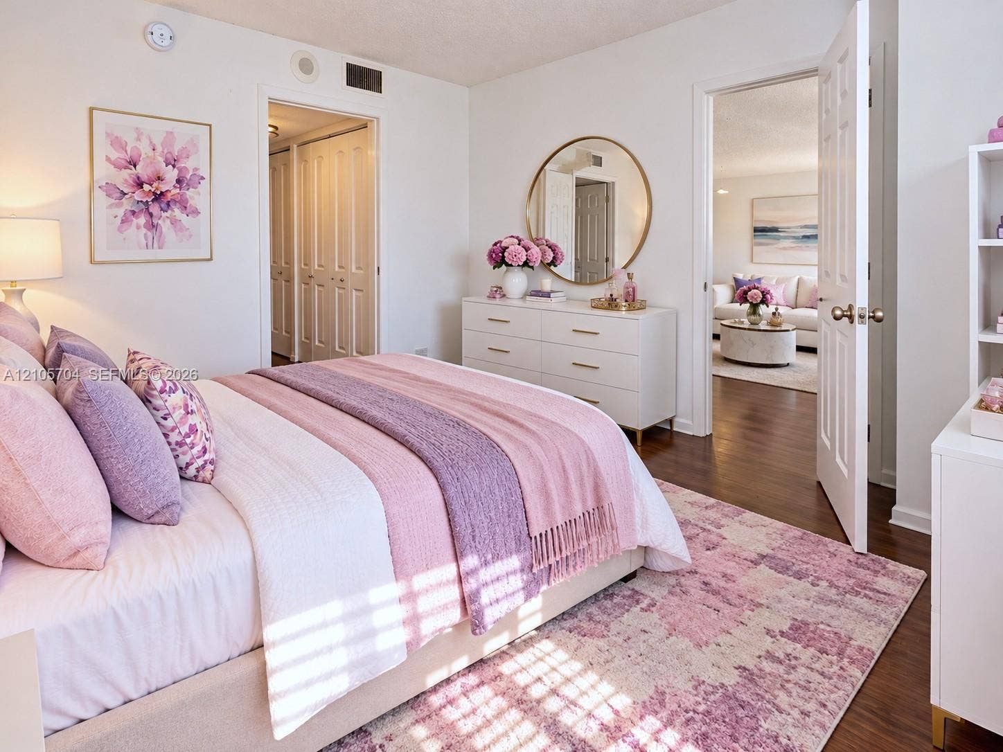 251 174th Street, #212, Sunny Isles Beach, Sunny Isles Beach, FL 33160 Wood-finish flooring, multi-panel interior doors, and a round wall-mounted mirror
