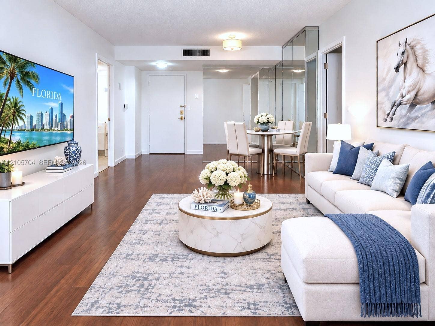 251 174th Street, #212, Sunny Isles Beach, Sunny Isles Beach, FL 33160 Open living area featuring wood-finish flooring, mirrored wall accents, and recessed lighting