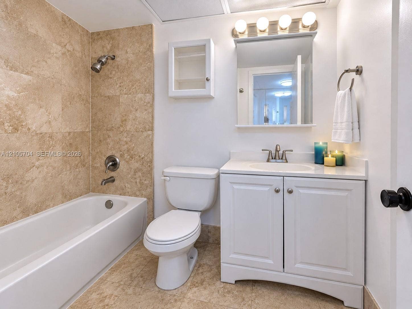 251 174th Street, #212, Sunny Isles Beach, Sunny Isles Beach, FL 33160 Grand lobby featuring polished stone tile flooring with decorative inlay, structural architectural columns, recessed tray ceilings, and a decorative sunburst chandelier