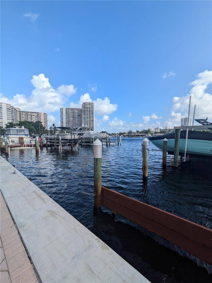 300 Three Islands Boulevard, #516, Hallandale Beach, FL 33009 Waterfront bulkhead featuring concrete paved perimeter, deep-water channel access, and multi-slip wooden piling dock system