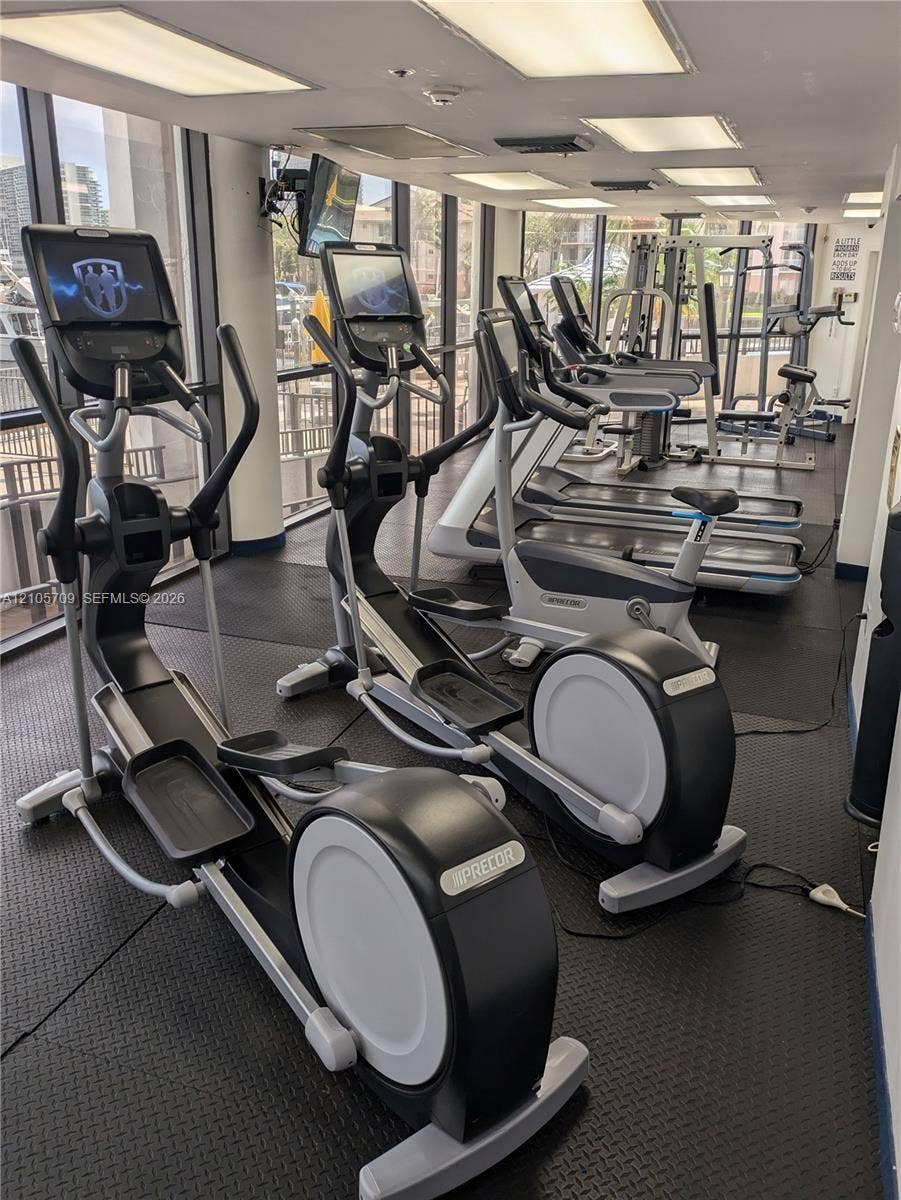 300 Three Islands Boulevard, #516, Hallandale Beach, FL 33009 Fitness center featuring rubberized flooring, floor-to-ceiling windows, and recessed ceiling lighting