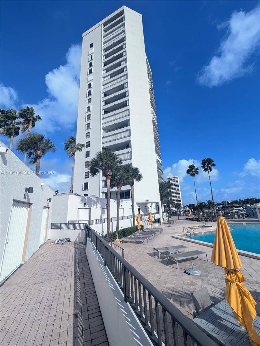 300 Three Islands Boulevard, #516, Hallandale Beach, FL 33009 High-rise building featuring private balconies, paver-lined pool deck, and outdoor swimming pool