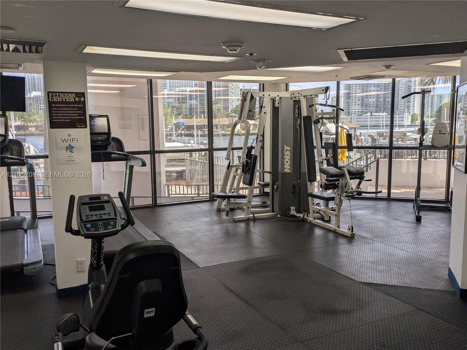 300 Three Islands Boulevard, #516, Hallandale Beach, FL 33009 Fitness center featuring floor-to-ceiling windows, rubberized flooring, and recessed ceiling lighting