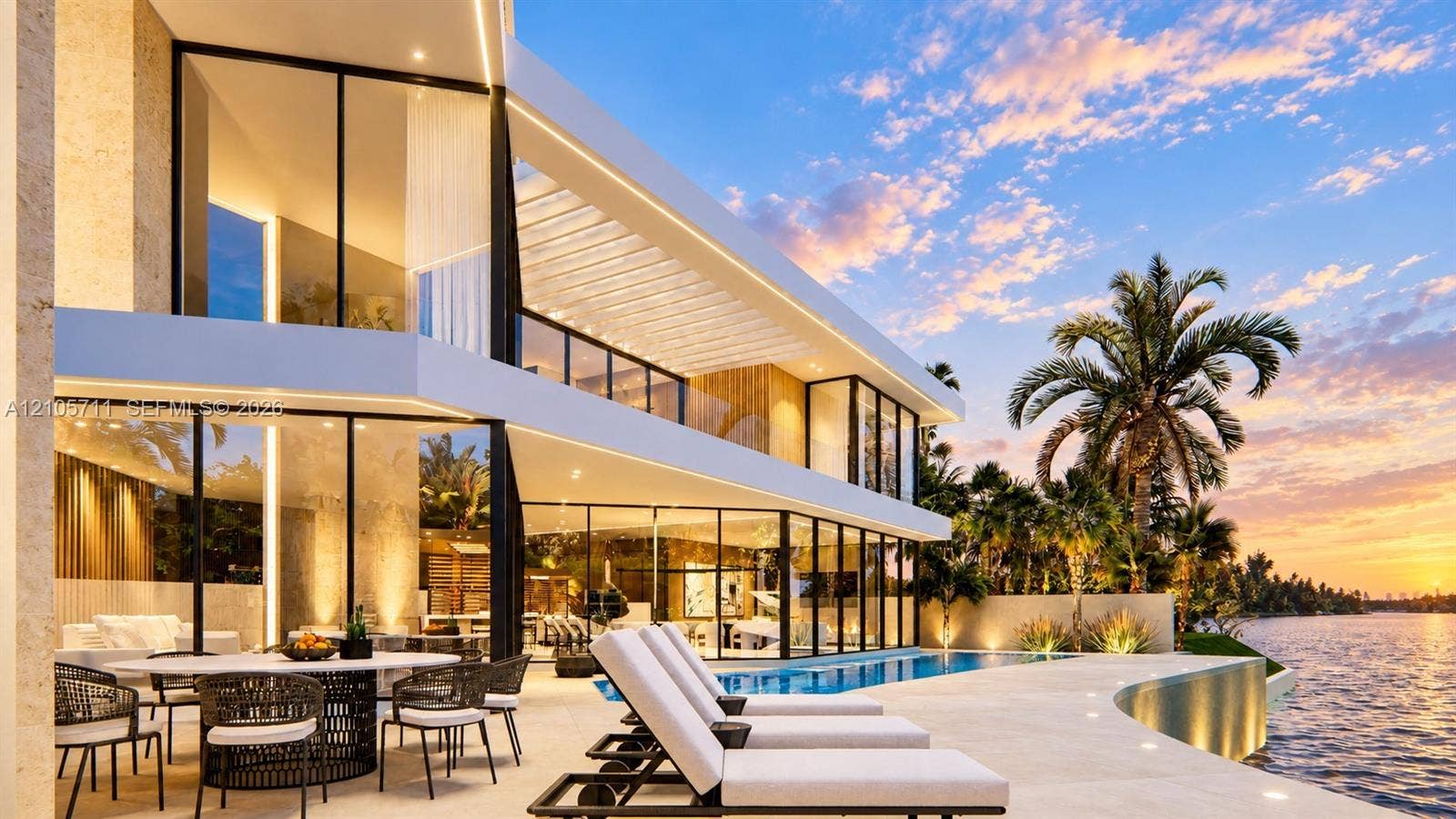 839 Orchid Drive, Boca Raton, FL 33432 Modern waterfront estate featuring floor-to-ceiling glass walls, a covered stone patio, an infinity-edge swimming pool, and an expansive balcony with glass railings
